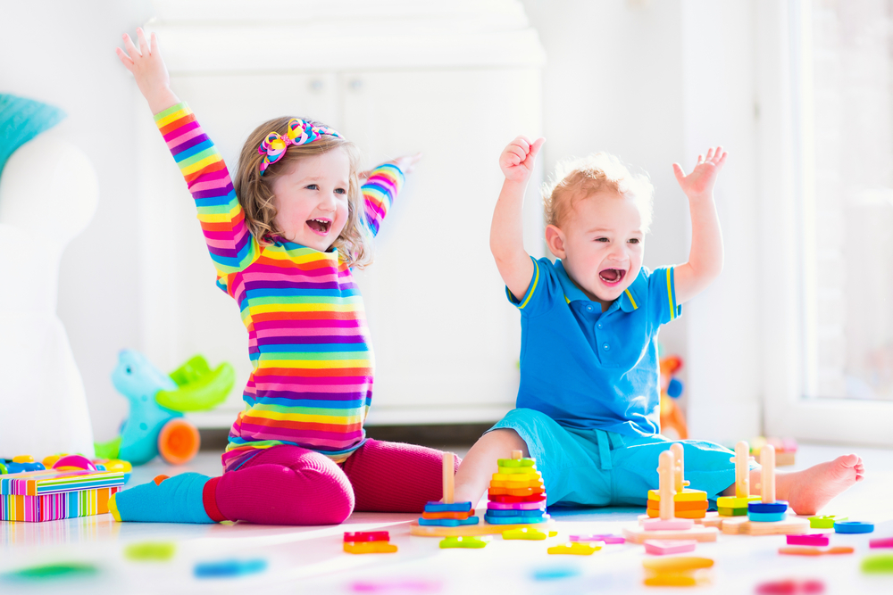 Boy and girl excited about playing with toys