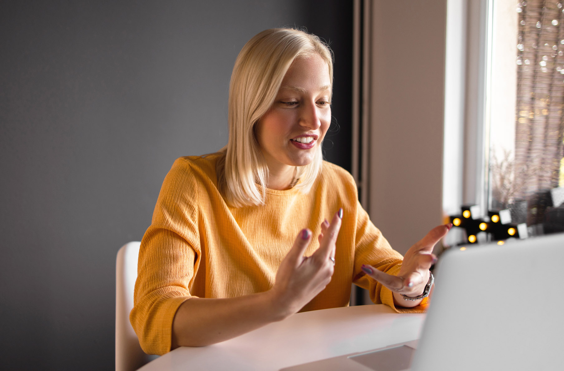 An image of a woman speaking virtually with someone.