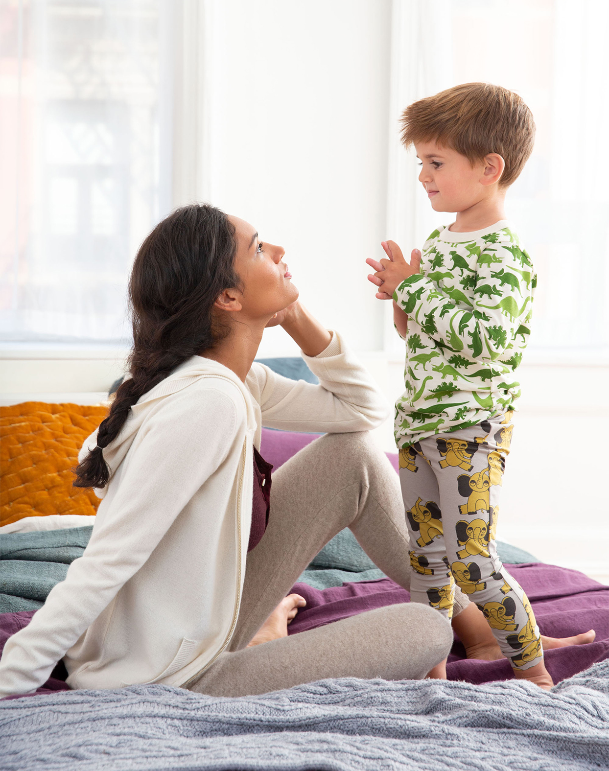 mother and son talking on bed