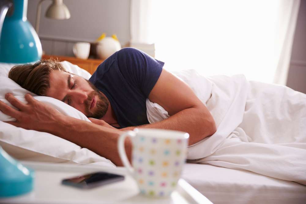 man sleeping in bedroom