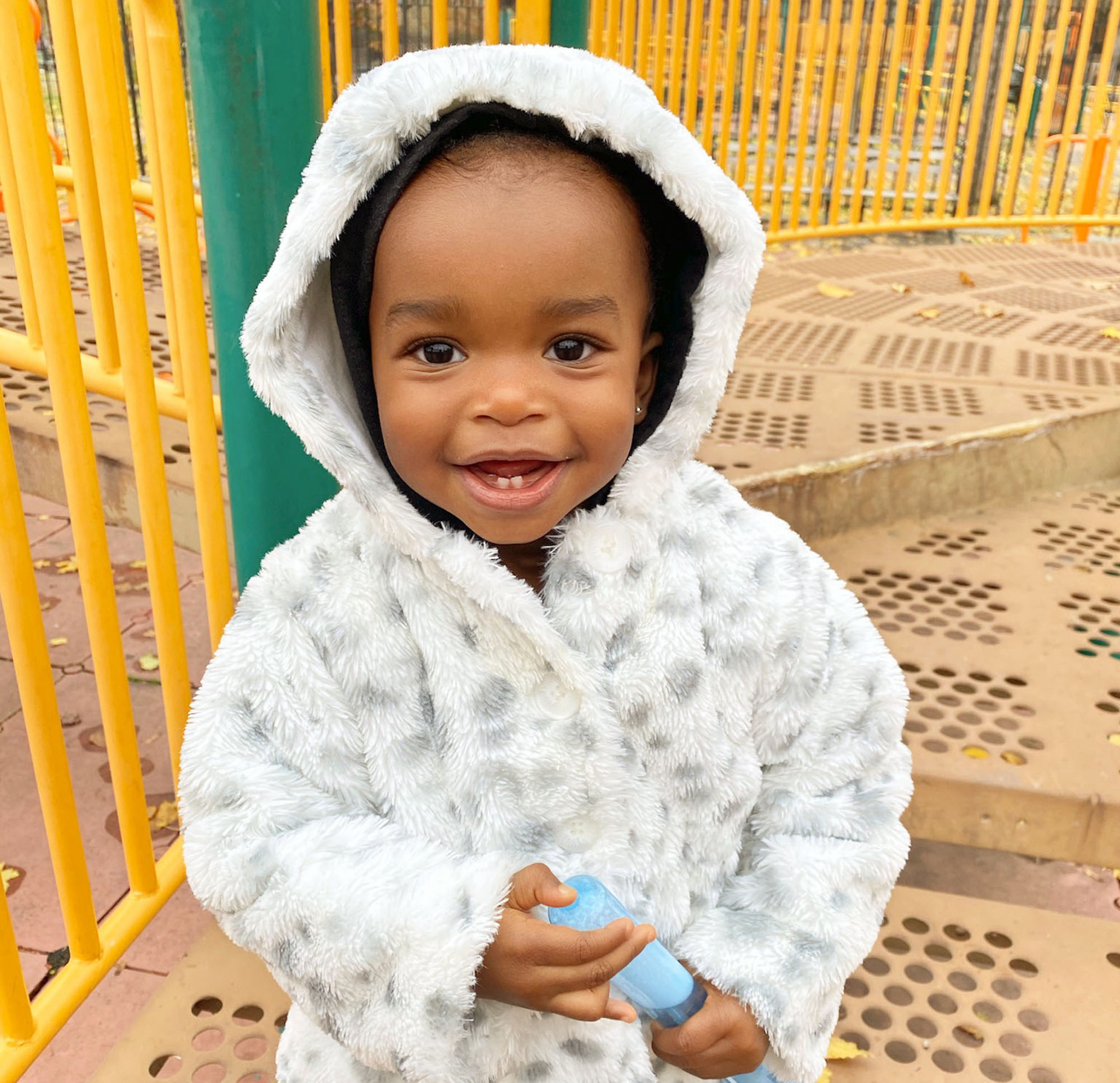 Amara at the park in white coat