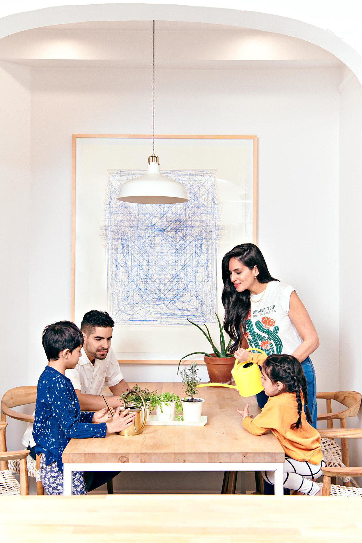 Family at table watering plants