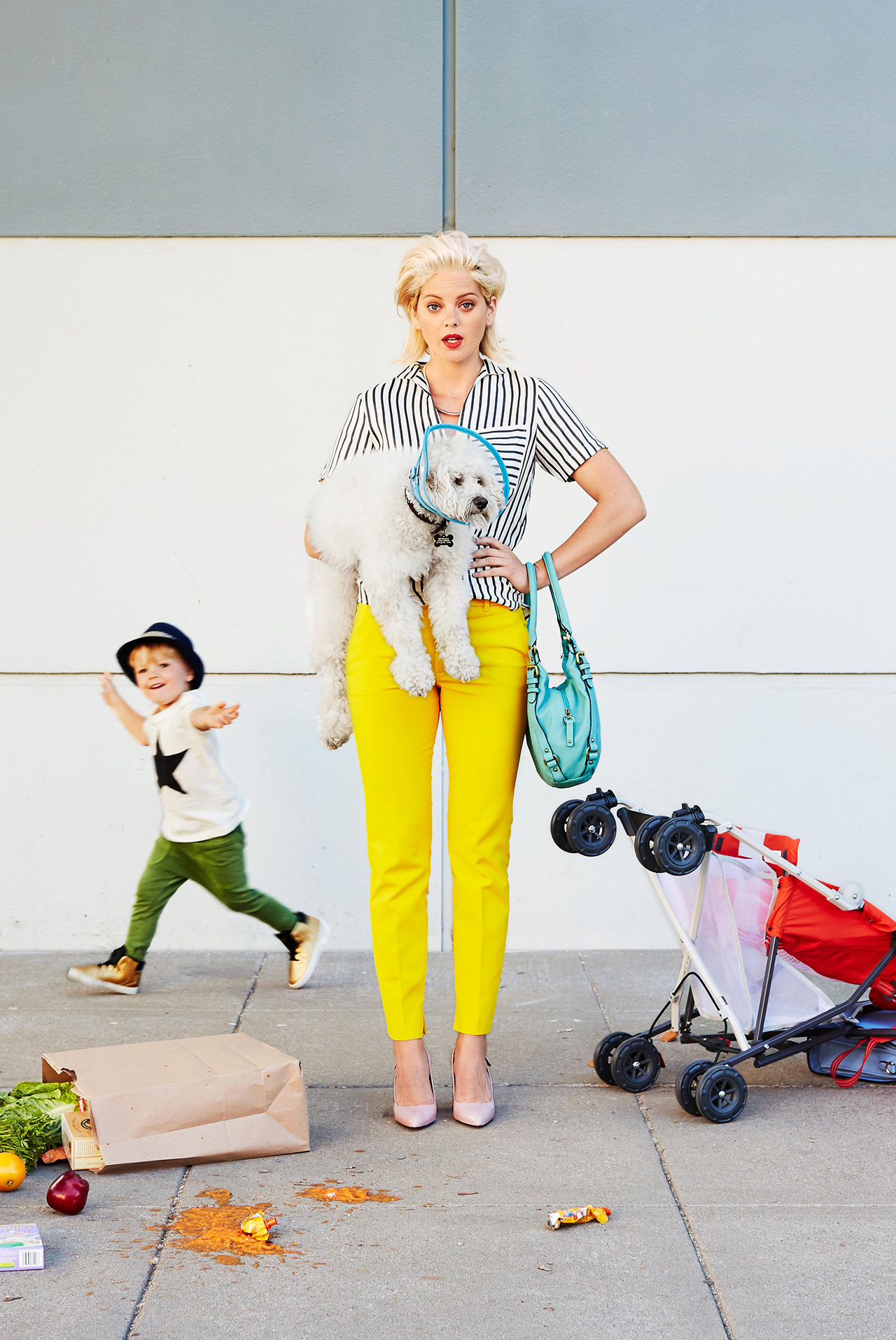 Parent standing on sidewalk with child and mess around her