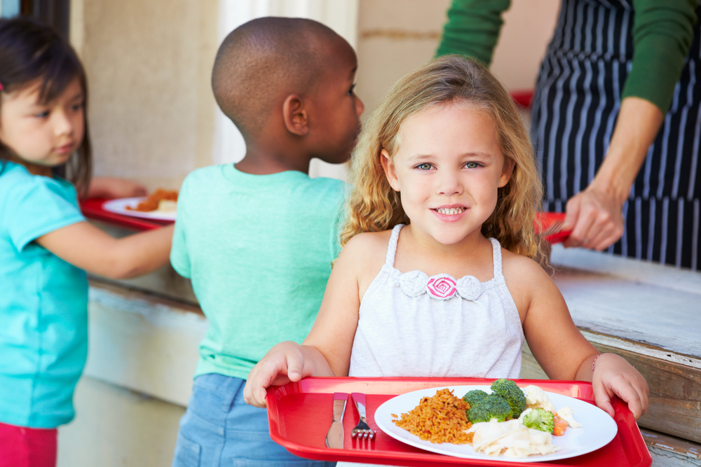 Healthier school lunches Girl with tray of cafeteria food