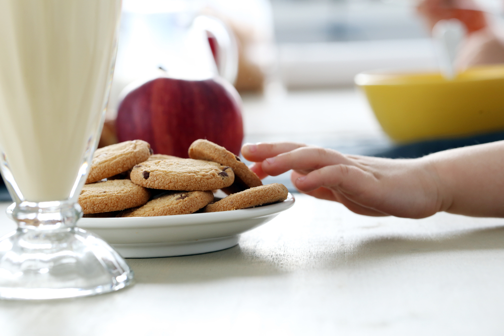 child hand reaching for cookies