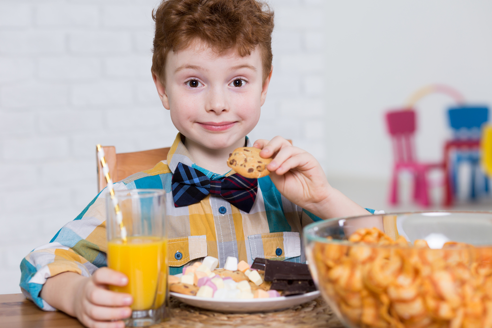 Boy eating cookies and chips