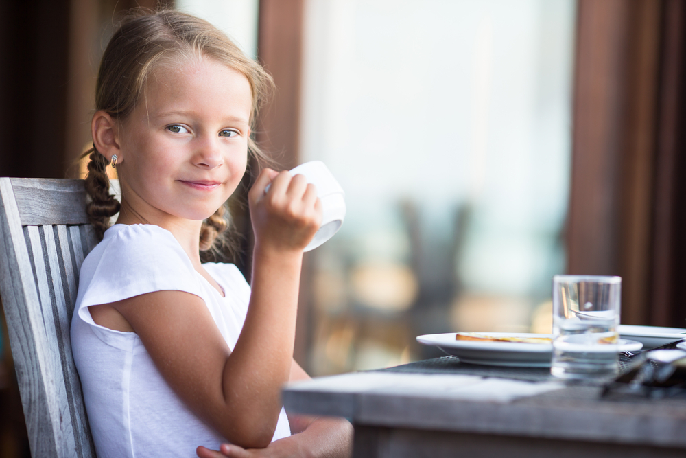 Girl with Pigtails Drinking Tea