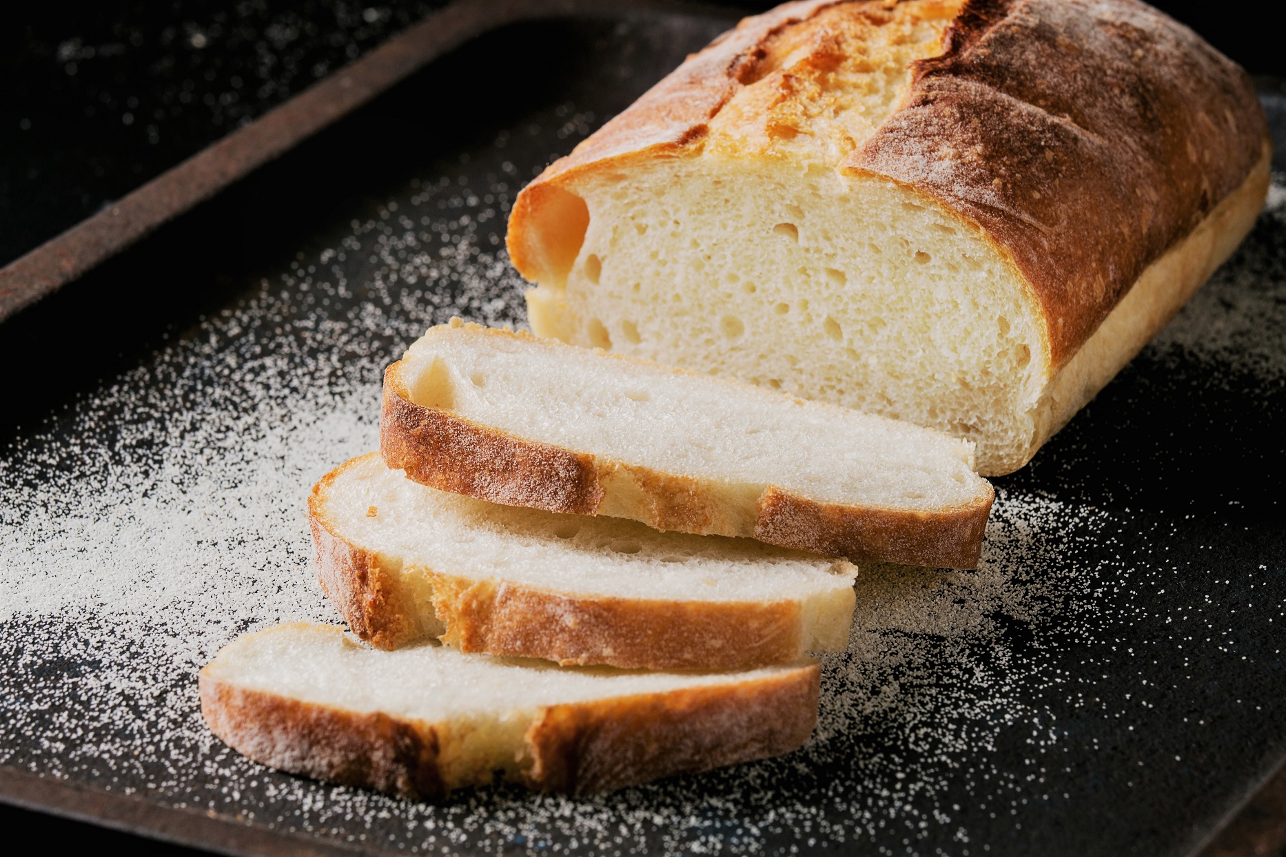 Loaf of Sliced White Bread on Black Tray