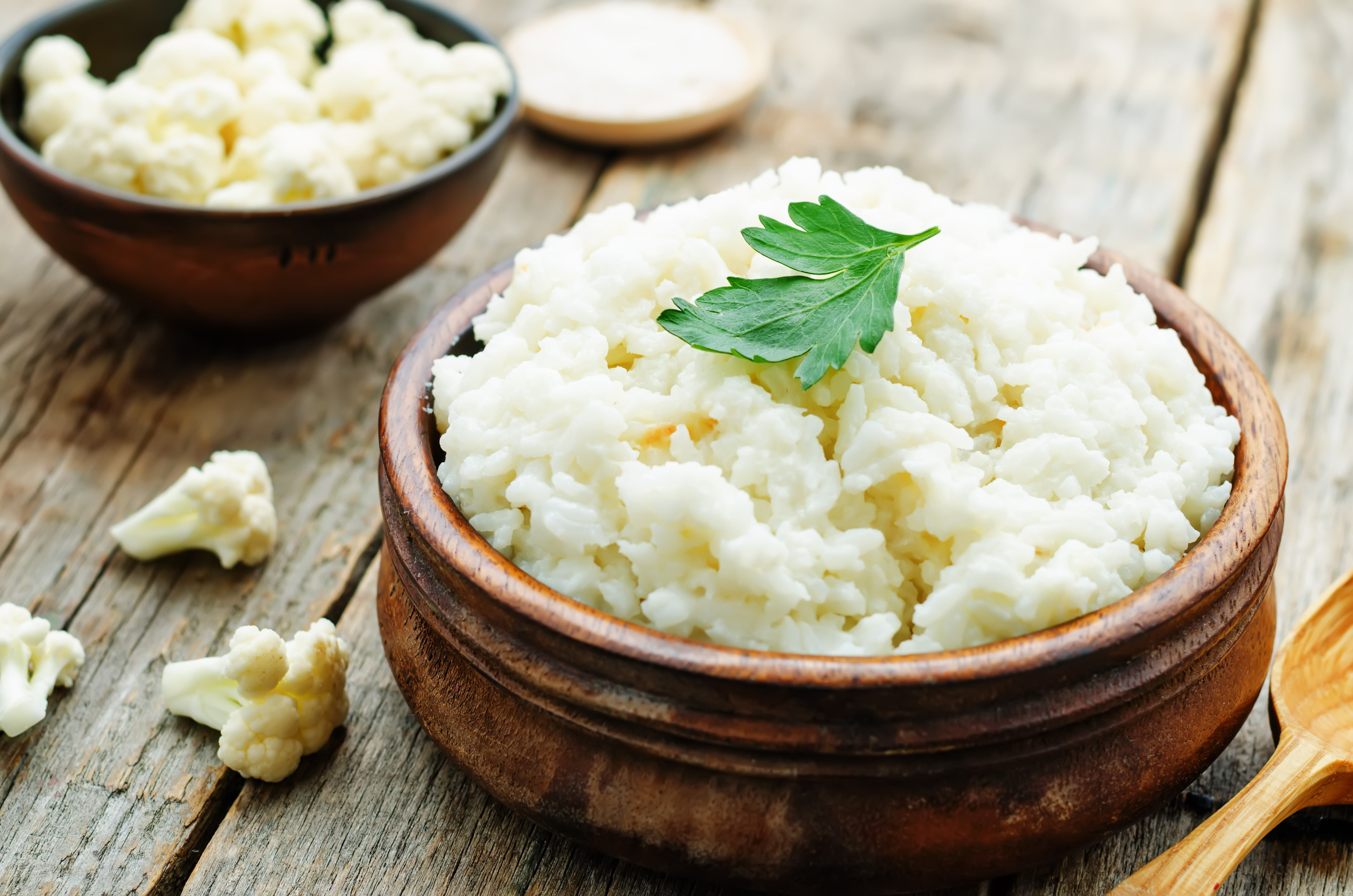 Cauliflower Rice in Wooden Bowl on Table