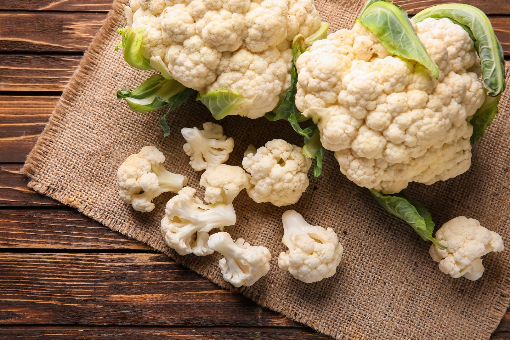 Fresh Cauliflower on Wooden Table and Burlap