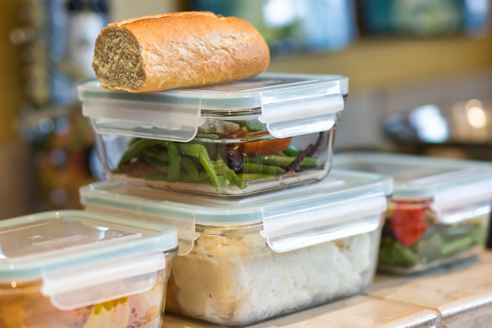 Stack of Containers of Leftover Food and Bread