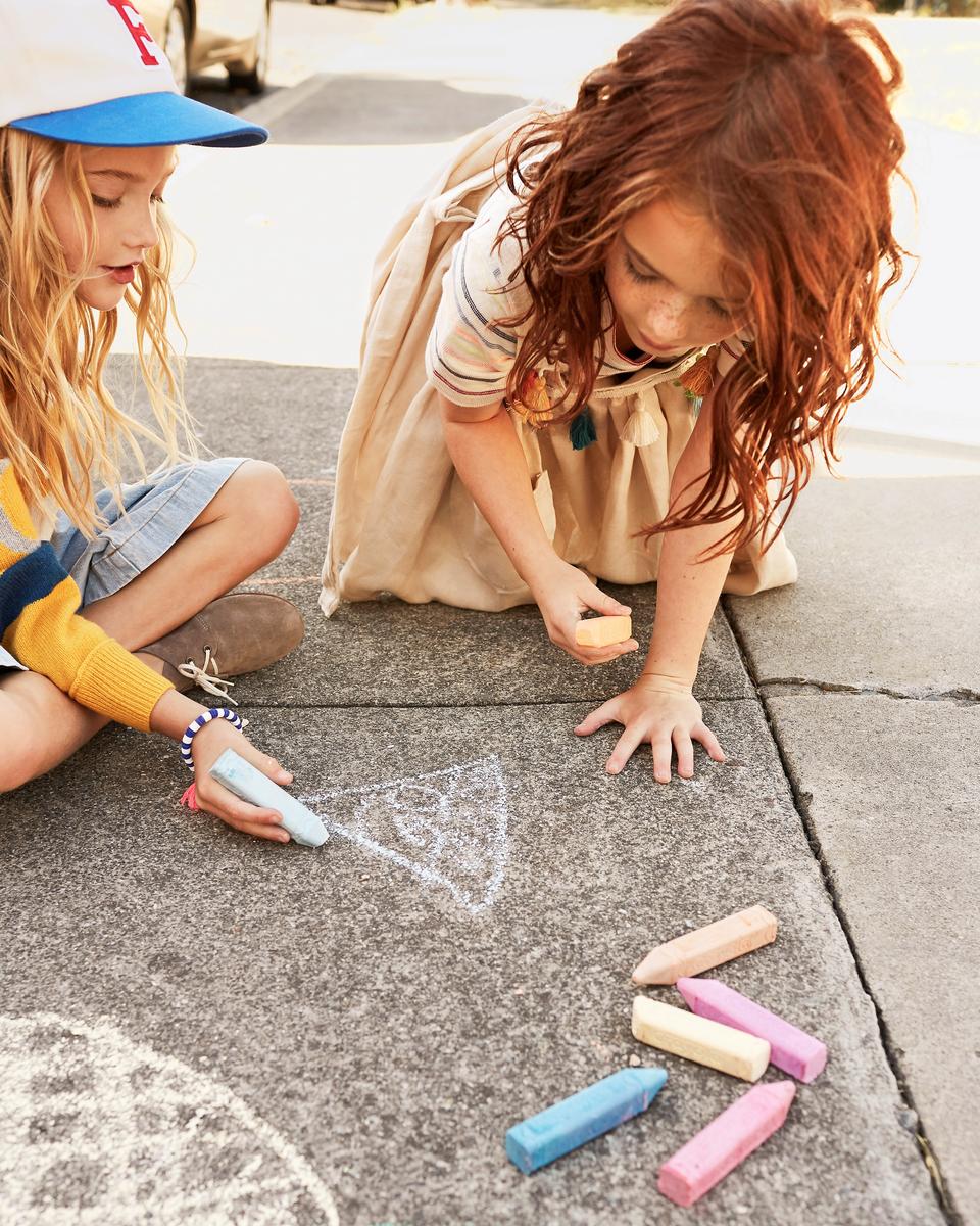 Girls Playing With Chalk On Sidewalk