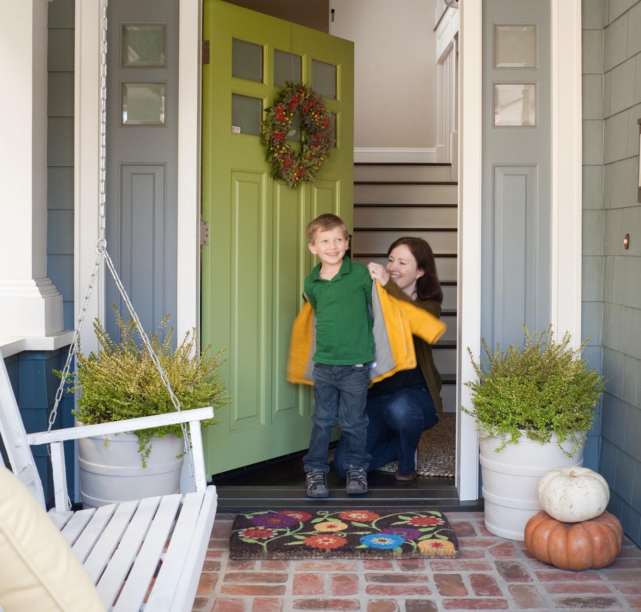 Mom Putting Jacket On Son Walking Out The Door