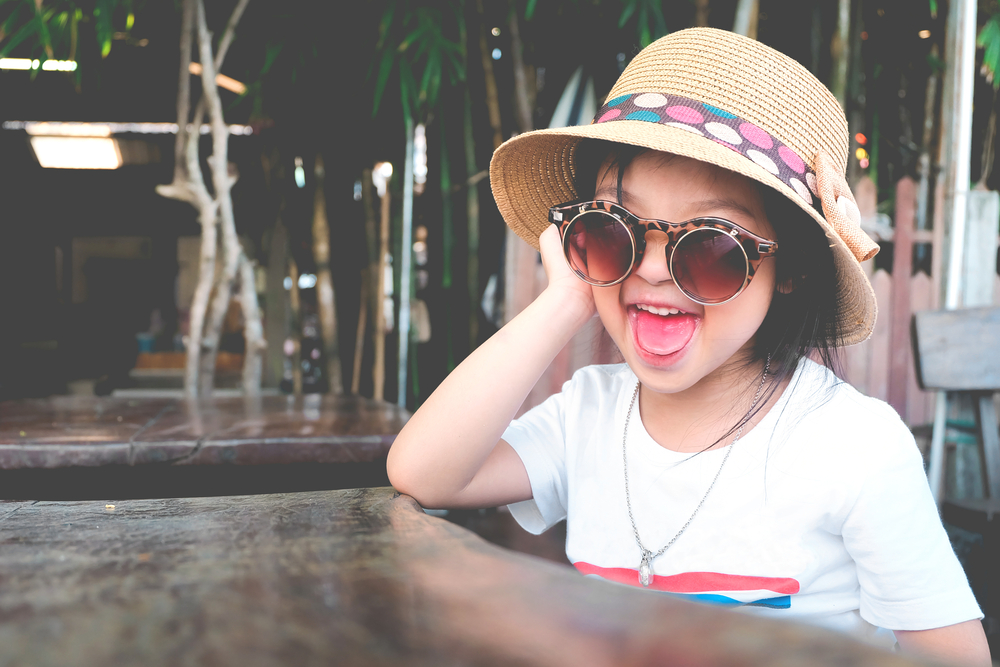 little girl wearing silly sunglasses