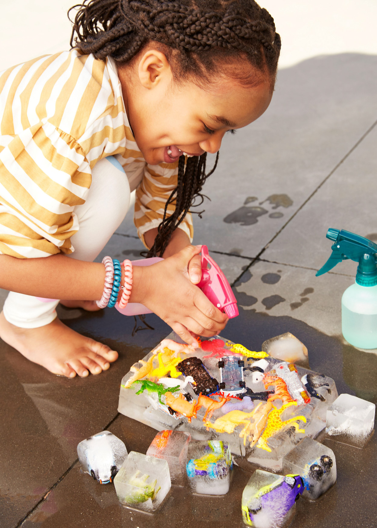 girl playing with frozen water toys