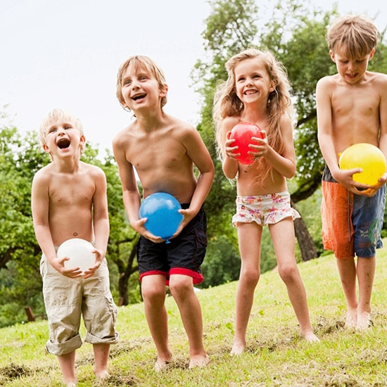 Kids holding water balloons