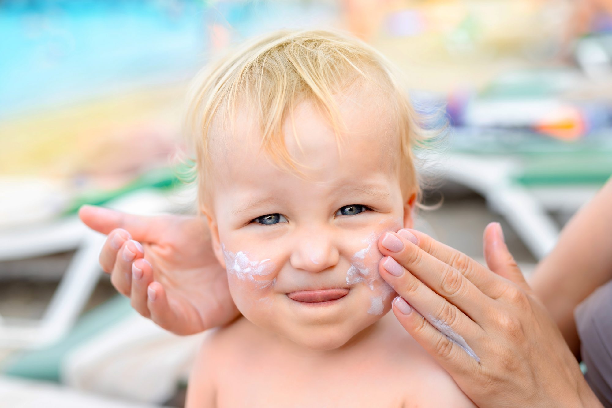 An image of a baby getting lotion put on them.