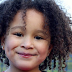 smiling-young-girl-with-curly-black-hair.jpg