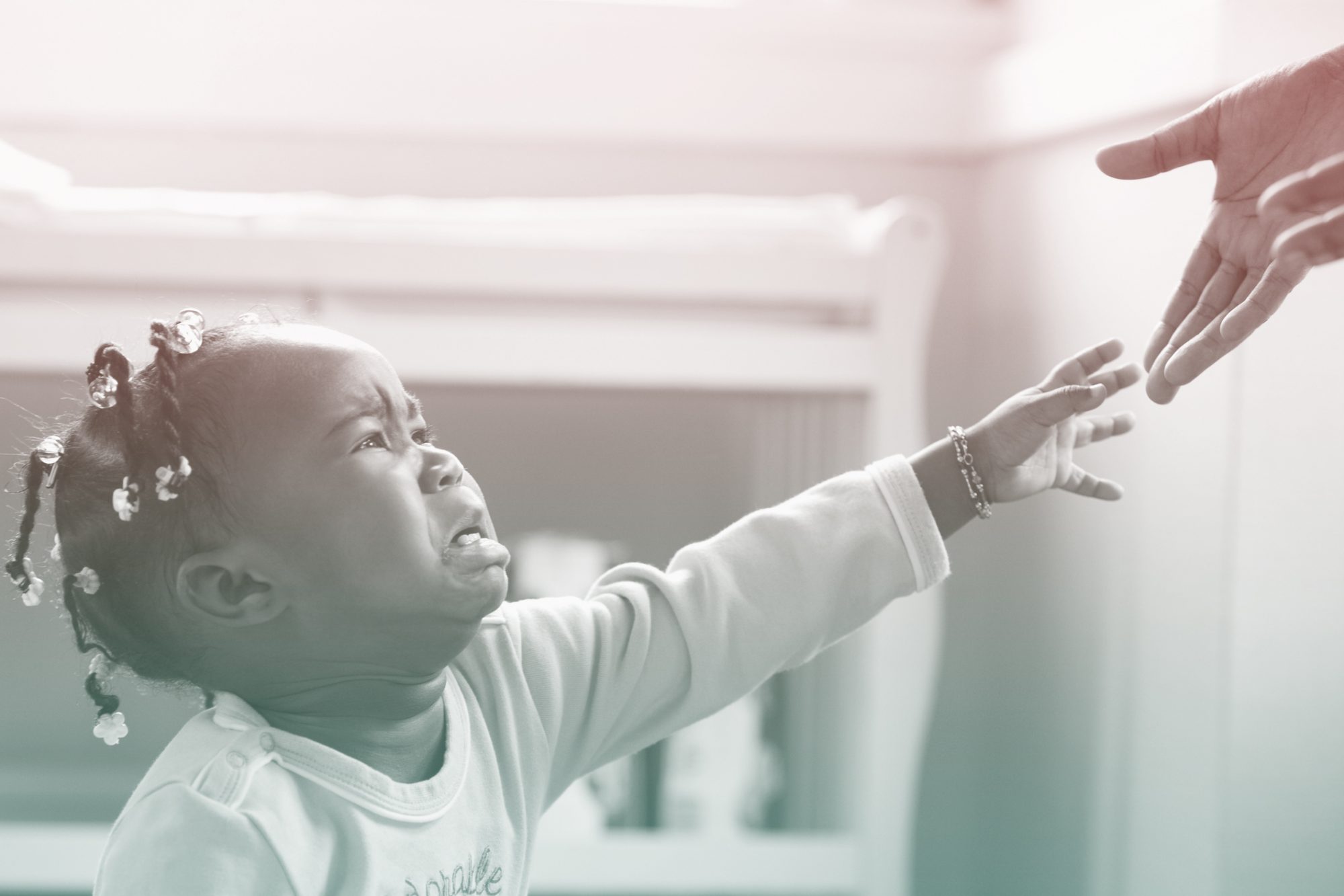 African girl crying and reaching upward