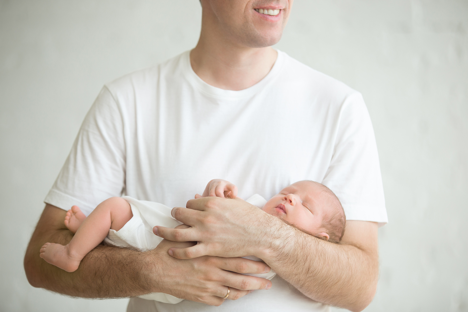 Dad holding newborn baby